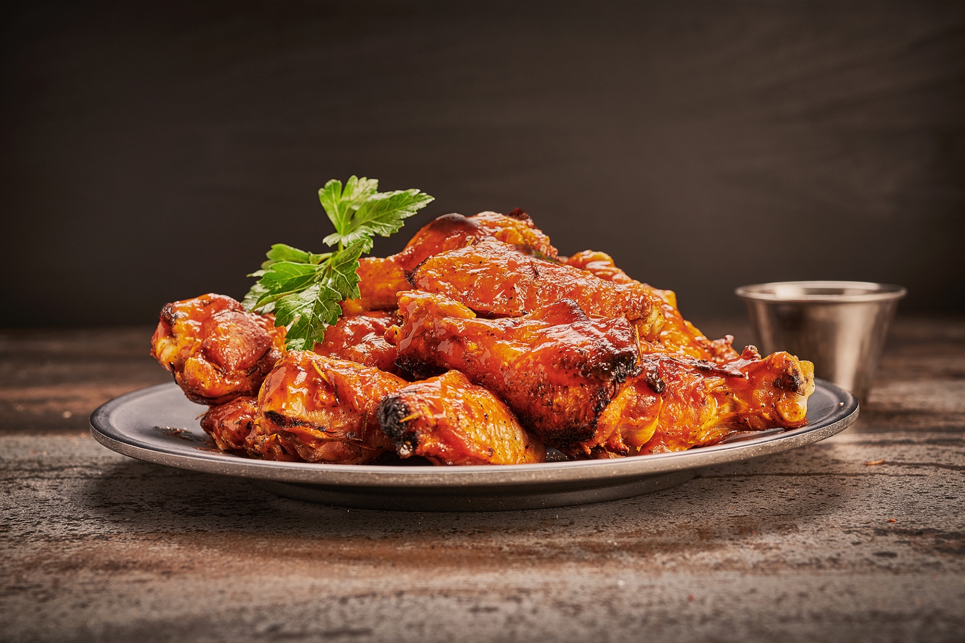 Juicy coal-fired chicken wings with golden-brown charred skin served fresh at Anthony’s Coal Fired Pizza.